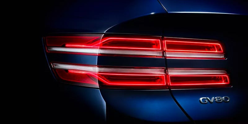The rear driver side tail light of an all-new Blue 2024 Genesis GV80. - Genesis of Baton Rouge, LA