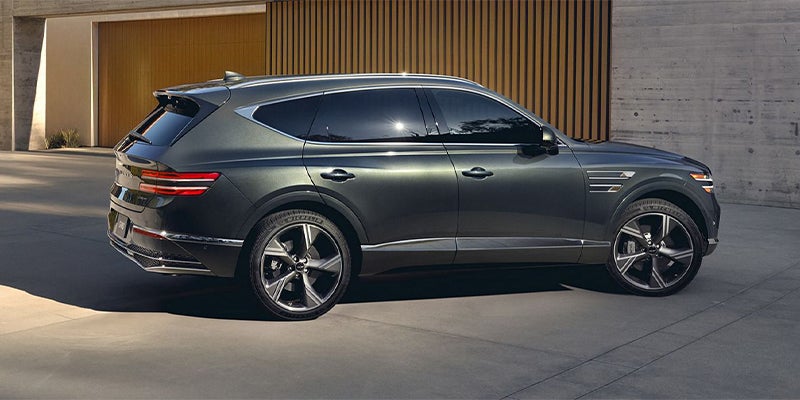 A Genesis GV80 midsize luxury SUV, finished in a dark green exterior color.